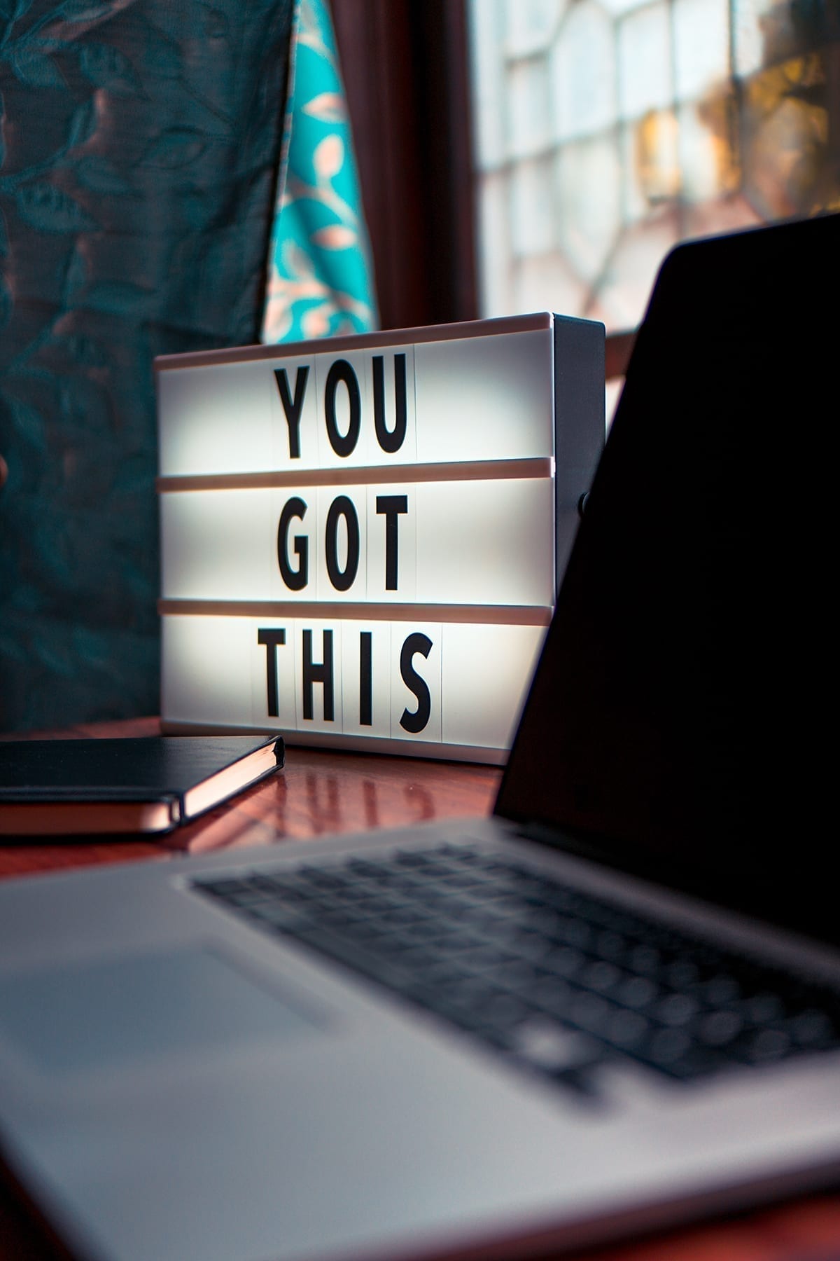 home office during the COVID-19 outbreak with a lighted sign on the desk with the words 'you got this'
