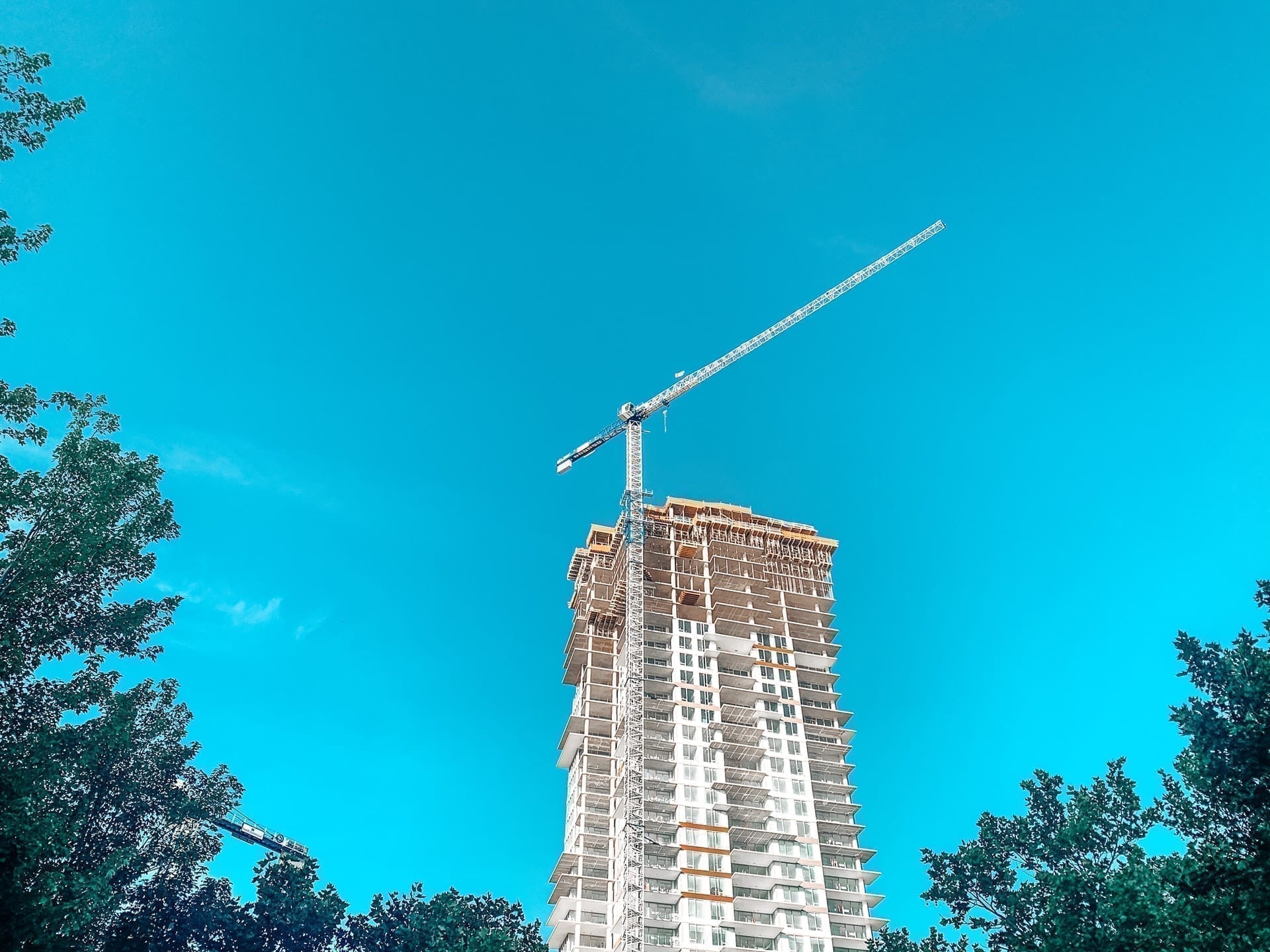 Condo in development with a crane in foreground; highlighting mortgage pre-approval before buying a property like a condo, house, or townhome