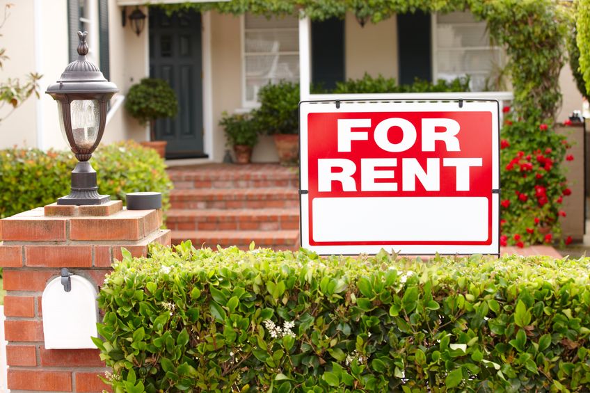 a red For Rent sign, illustrating a rental property in Kelowna