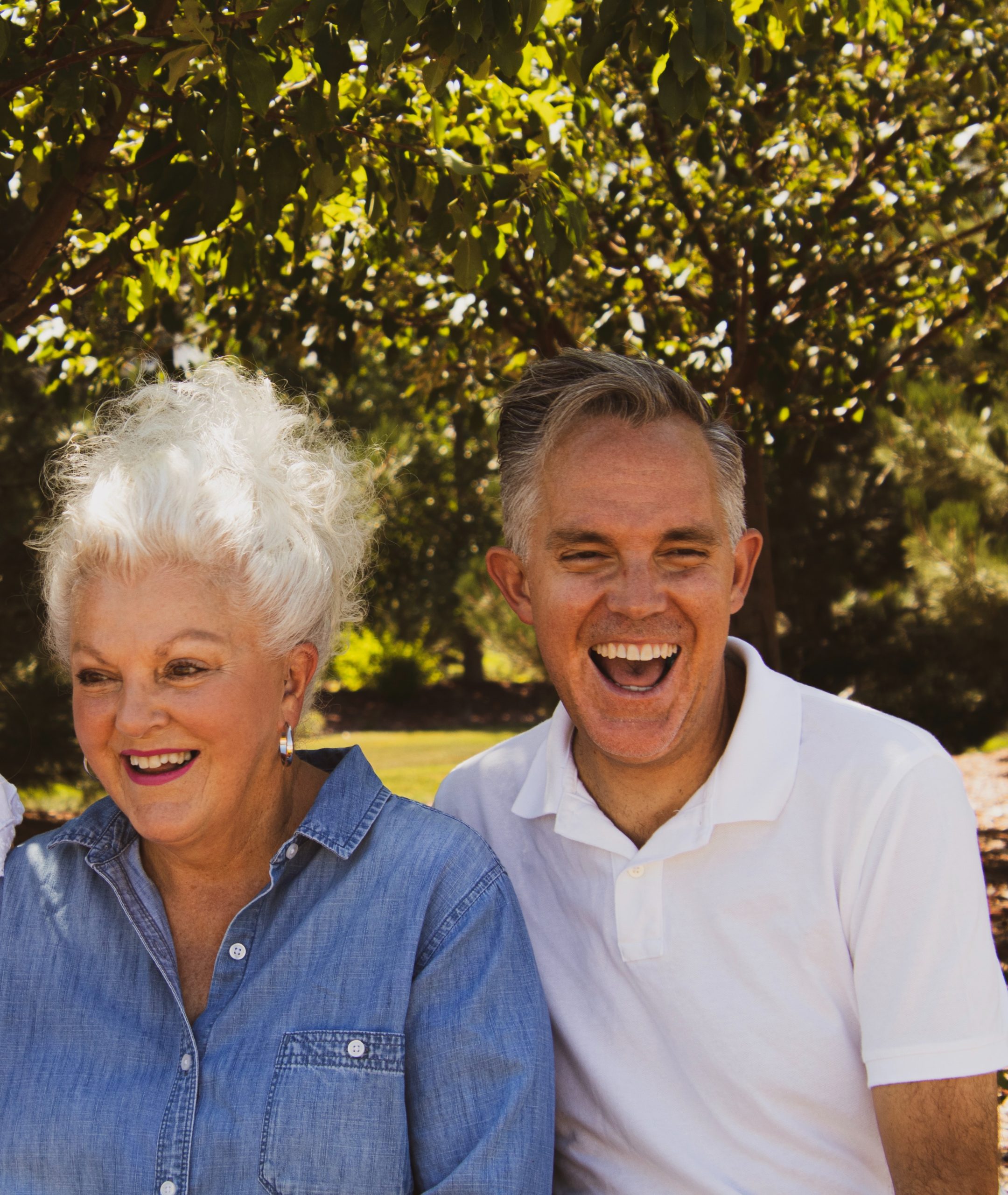 Retired couple sitting side by side smiling; pertaining to option for getting equity from your home.