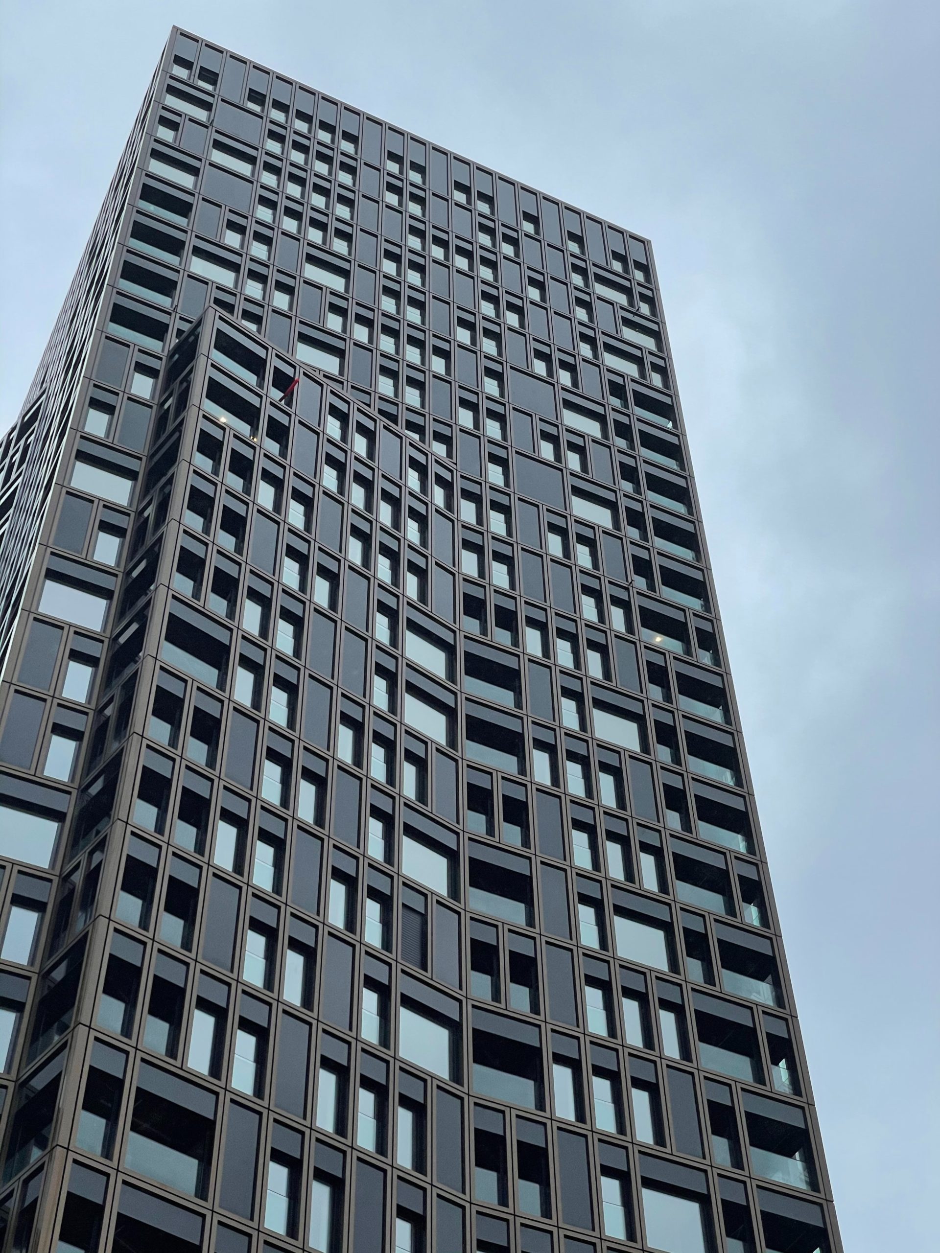 tall condo building against a grey sky, with strata fees incorporated into the mortgage application
